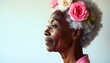 © BTNKO - An old African American woman with a serene expression, her face framed by a beautiful floral headpiece composed of soft pastel colors