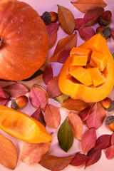 fresh whole pumpkin, pieces of pumpkin on a background of autumn leaves. Autumn background.