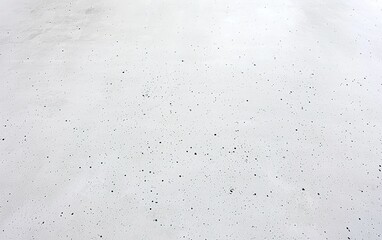 Poster - Smooth, light-colored concrete floor with a subtle speckled texture in a bright, well-lit space
