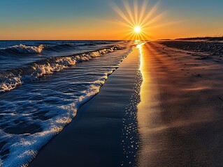 Wall Mural - The sun dipping below the horizon casting long shadows on the beach as the waves gently roll onto the shore
