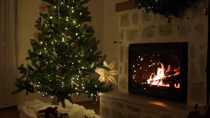 Wall Mural - Merry Christmas! Stylish decorated christmas tree with vintage ornaments, wrapped presents and cozy burning fireplace with decor in evening. Atmospheric christmas eve at home, holiday footage