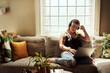 © Malambo/peopleimages.com - Laptop, movies and woman with headphones, house and chilling with radio, streaming and comfortable. Home, sound and calm on sofa, listening and person in living room, podcast and rest in apartment