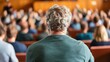 © Anna - A crowd of people attentively listens to a speaker at a seminar focused on effective communication strategies in a conference hall setting