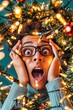 © Artur Lipiński - Surprised man tangled in glowing Christmas lights with a shocked expression during holiday chaos