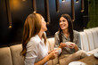 © Mediteraneo - Two girl best friends having out at the restaurant. Drinking coffee and orange juice. They gossip, laugh and have fun time.