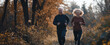 © David Giraud - Un couple de personnes âgées souriantes faisant du jogging dans la nature avec des vêtements de sport, mode de vie actif, attitude saine, image avec espace pour texte.