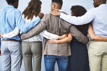 Canvas Print - Back, group and business people with hug in office for team building, unity and support in meeting. Corporate, employees and worker with gesture for motivation, collaboration and trust at company