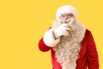 Poster - Santa Claus with glass of beer on yellow background