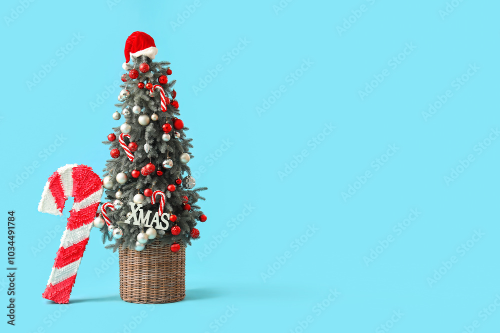 Beautiful Christmas tree and candy cane pinata on color background