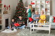 © Pixel-Shot - Happy family with Christmas tree spending time together at home