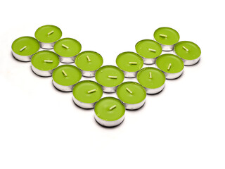 stack of green color tea candle on white background. apple or natural earth flavor house decoration.