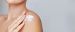 © Kateryna Zghurska - Beauty portrait of a woman applying moisturizing body care cream or lotion to her shoulder, emphasizing skincare and sskin hydration on a soft, neutral background, bunner with a copy space