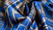 © Justlight - A rich royal blue silk scarf with a bold geometric pattern evocative of the opulence and geometric motifs popular in Art Deco design.
