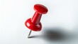 © adobedesigner - A close-up of a single bright red push pin with a metallic needle, isolated on a white background