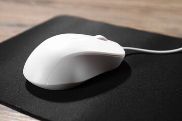 Sticker - Computer mouse with mousepad on wooden table, closeup