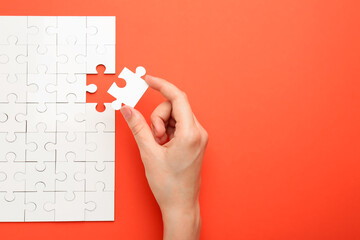 Sticker - Woman solving white puzzle on red background, closeup. Space for text