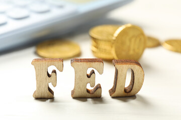 Wooden letters Fed (Federal Reserve System) on white table, closeup