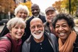 © Vorda Berge - Smiling group portrait of diverse seniors taking selfie in the city