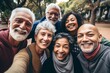 © Vorda Berge - Smiling group portrait of diverse seniors taking selfie in the city