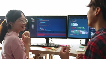 Slow motion back end software developer engineer for computer programming working together on debugging writing computing code, solving complex algorithms display on monitor in office. Burgeoning
