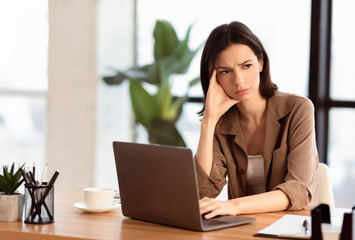 Aufkleber - What To Do. Puzzled confused woman thinking hard concerned about problem solution looking aside, using laptop, copyspace