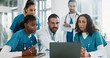 © PeakPoints/peopleimages.com - Doctor, team or laptop with discussion in clinic for healthcare treatment innovation or IRB approval report. Diversity, nurse or medical staff in hospital boardroom with technology for patient record