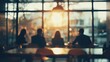 © saranya - blurred photo of business people sitting around the table in an office, captured from behind and in focus, symbolizing collaboration within company or between different quaint style icons.