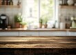 © tolem929 - A rustic wooden table top with a blurred image of a kitchen in the background.