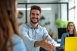 © useful pictures - Young Caucasian businessman smiling and reaching out for a handshake in a modern office setting during the day
