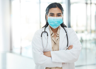 Canvas Print - Portrait, woman and doctor with face mask in hospital of healthcare services, ppe safety and medical compliance. Girl, surgeon and arms crossed for virus danger, wellness risk and about us of surgery