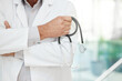 © CineLens2024/peopleimages.com - Hands, man and doctor with arms crossed, stethoscope and confidence with equipment in clinic. Closeup, person and medical with professional, equipment and lab coat in hospital and career ambition