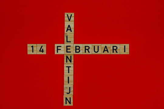 14 february Valentine in wooden blocks on a red background. Dutch language. Valentine's day concept