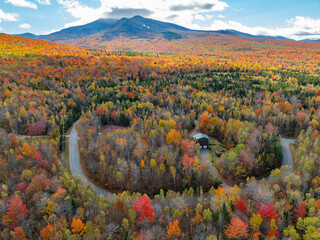 Wall Mural - aerial view of house in the autumn mountain forest