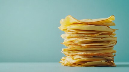 Poster - Freshly made golden crepes are stacked beautifully against a soft blue backdrop, perfect for serving at breakfast or dessert. Generative AI