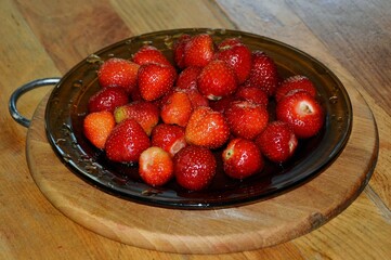 Medium sweet strawberries on a plate ready to eat.