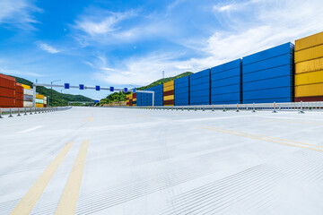 Sticker - Stacked containers and empty asphalt road at the port