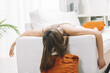 © Giulio_Fornasar - Young woman feeling exhausted is lying face down on couch