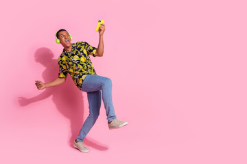 Poster - Full size photo of pretty young male dance headphones device wear trendy tropical print outfit isolated on pink color background