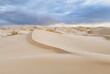 © AmazingAerialAgency - Aerial view of samalayuca dunes under a cloudy sky with expansive sand dunes, Ciudad Juarez, Mexico.