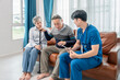 © Verin - asian senior couple giving a health interview to home visiting nurse,young male nurse using tablet to give advice on practice,concept of elderly health care,home health nursing,home health care