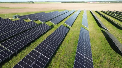 Canvas Print - Solar panel array in agricultural field producing electricity