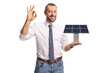 © Ljupco Smokovski - Professional man holding a small solar panel model and gesturing ok sign