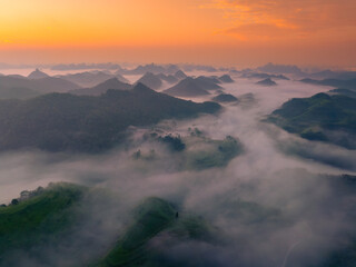 Orange sky and sea of clouds before sunrise. A peaceful, refreshing feeling. View of the hills surrounding Ba Quang, Ha Lang district, Cao Bang province, Vietnam