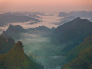 Orange sky and sea of clouds before sunrise. A peaceful, refreshing feeling. View of the hills surrounding Ba Quang, Ha Lang district, Cao Bang province, Vietnam