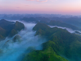 Orange sky and sea of clouds before sunrise. A peaceful, refreshing feeling. View of the hills surrounding Ba Quang, Ha Lang district, Cao Bang province, Vietnam