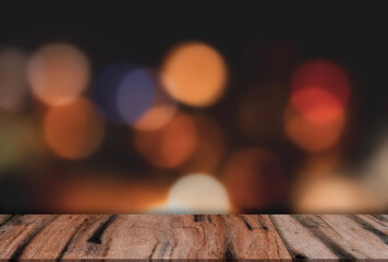 Wood table on Christmas lights bokeh on black background for podium product display presentation,Studio Background Empty Brown Wooden Shelf with blurry light and copy space for New Year or Xmas banner