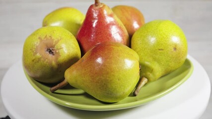 Wall Mural - Ripe pears on green plate.