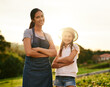 © FotoPush/peopleimages.com - Farm, portrait and woman with child, outdoor and gardening with mom, environment and smile for growth. Agriculture, arms crossed and helping for farming, sustainable and parent with kid and family
