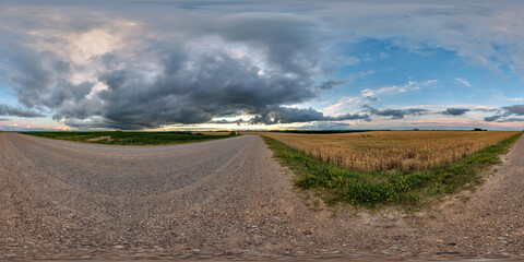 Wall Mural - hdri 360 panorama on gravel road among fields in nasty evening before storm and sunset in equirectan