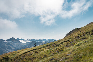 small person walking up big mountain. high quality photo